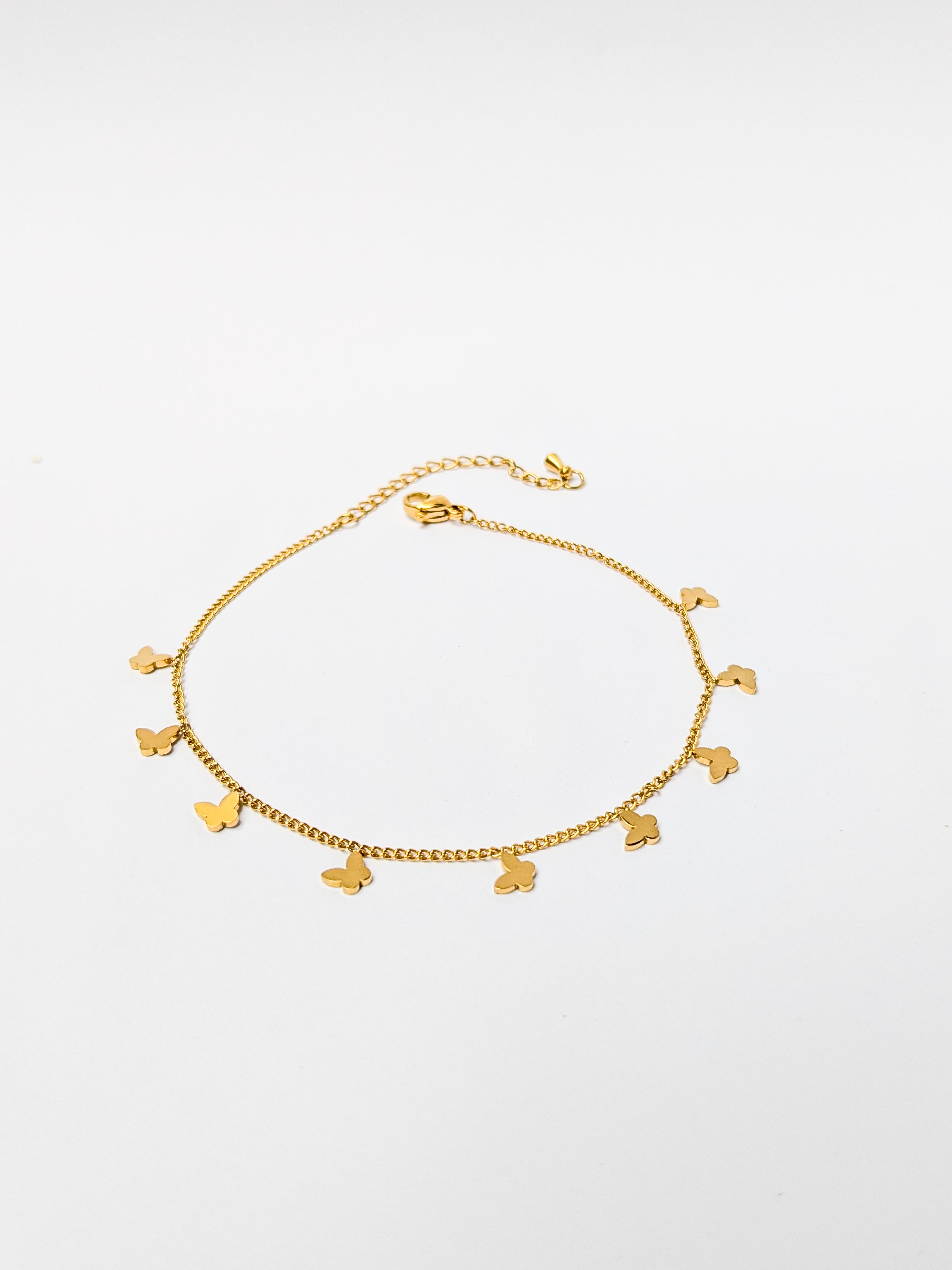 Gold charm bracelet with multiple small butterfly charms