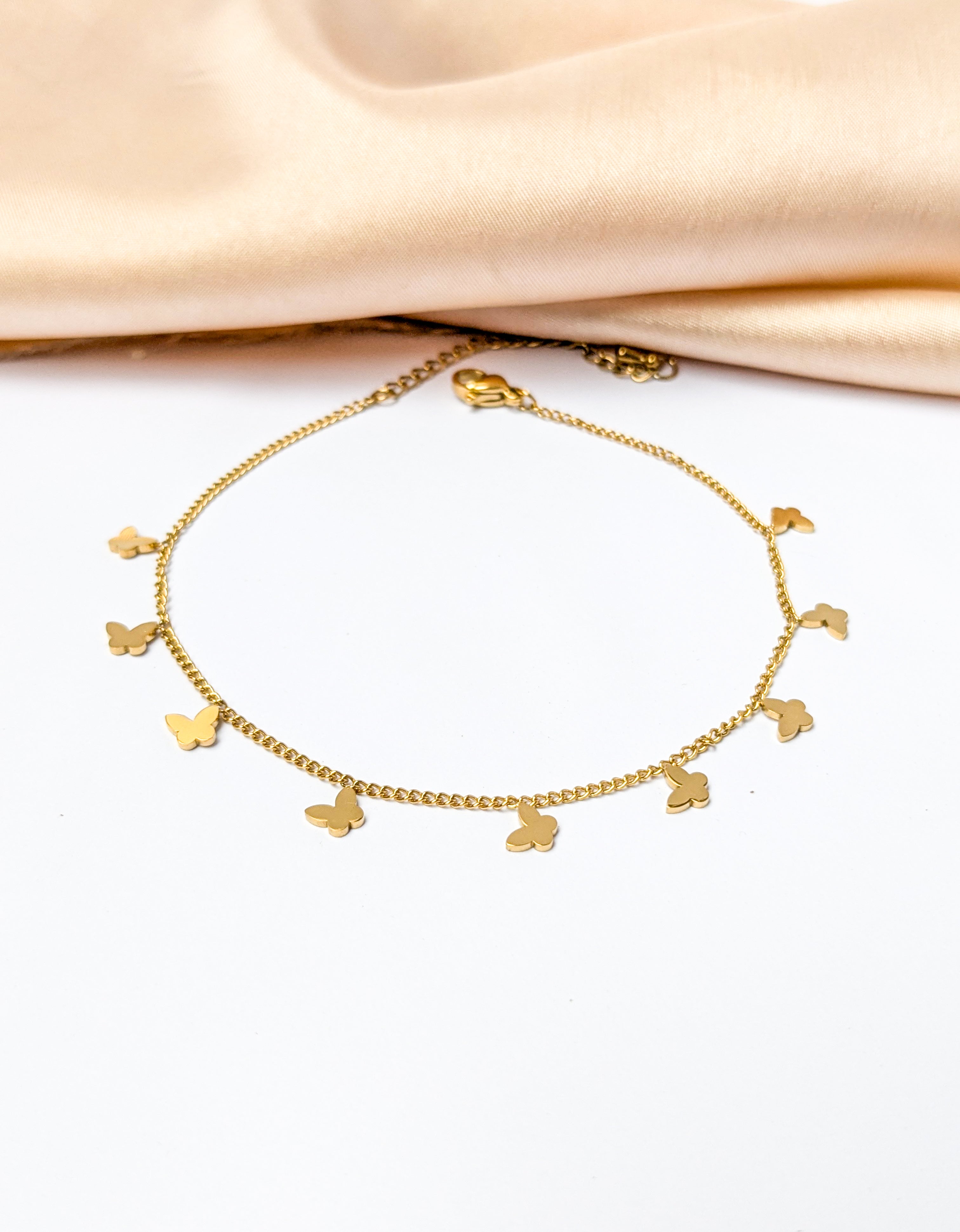 Gold charm bracelet with multiple small butterfly charms