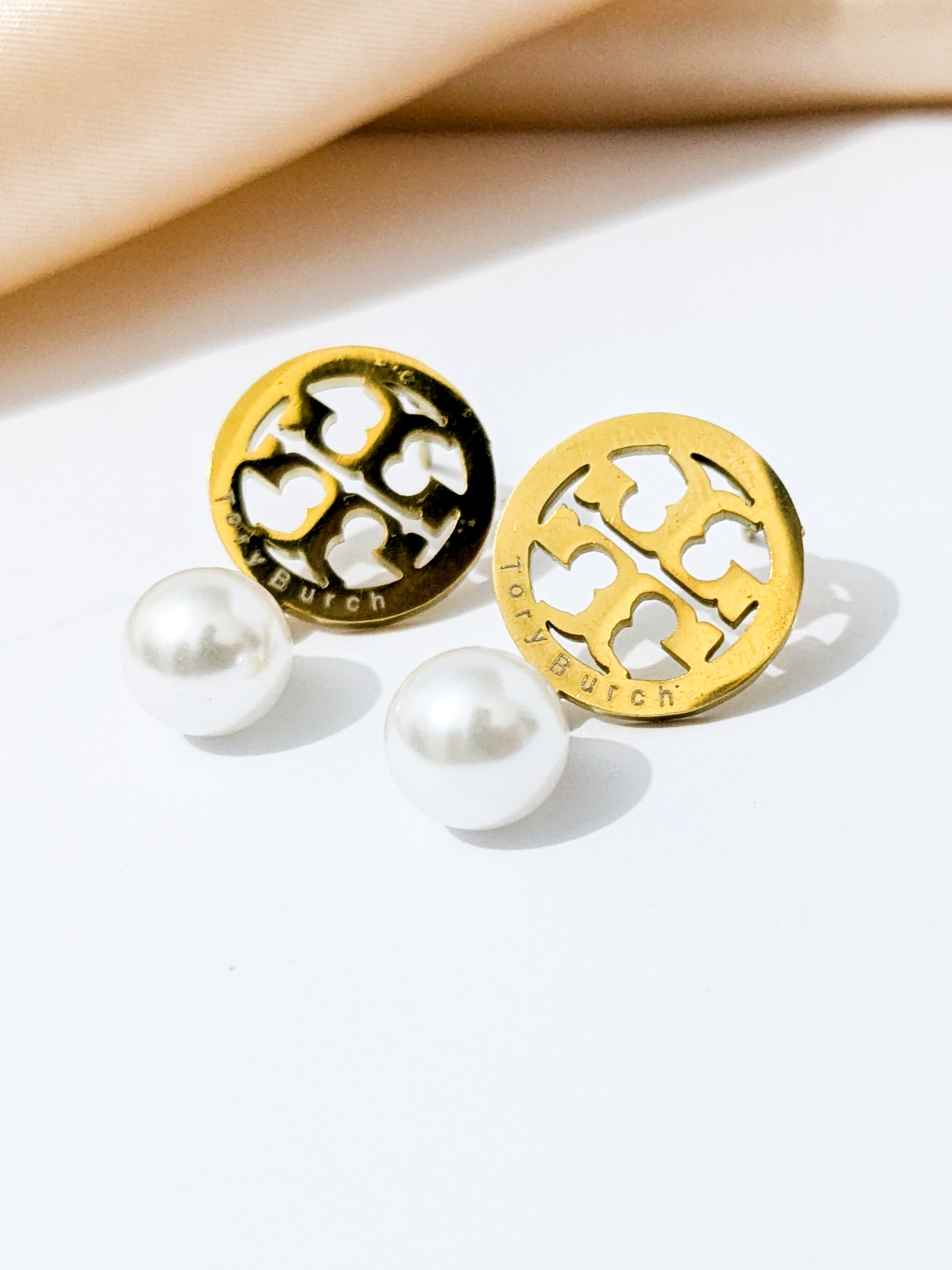 A Pair of Tory Burch pearl drop earrings