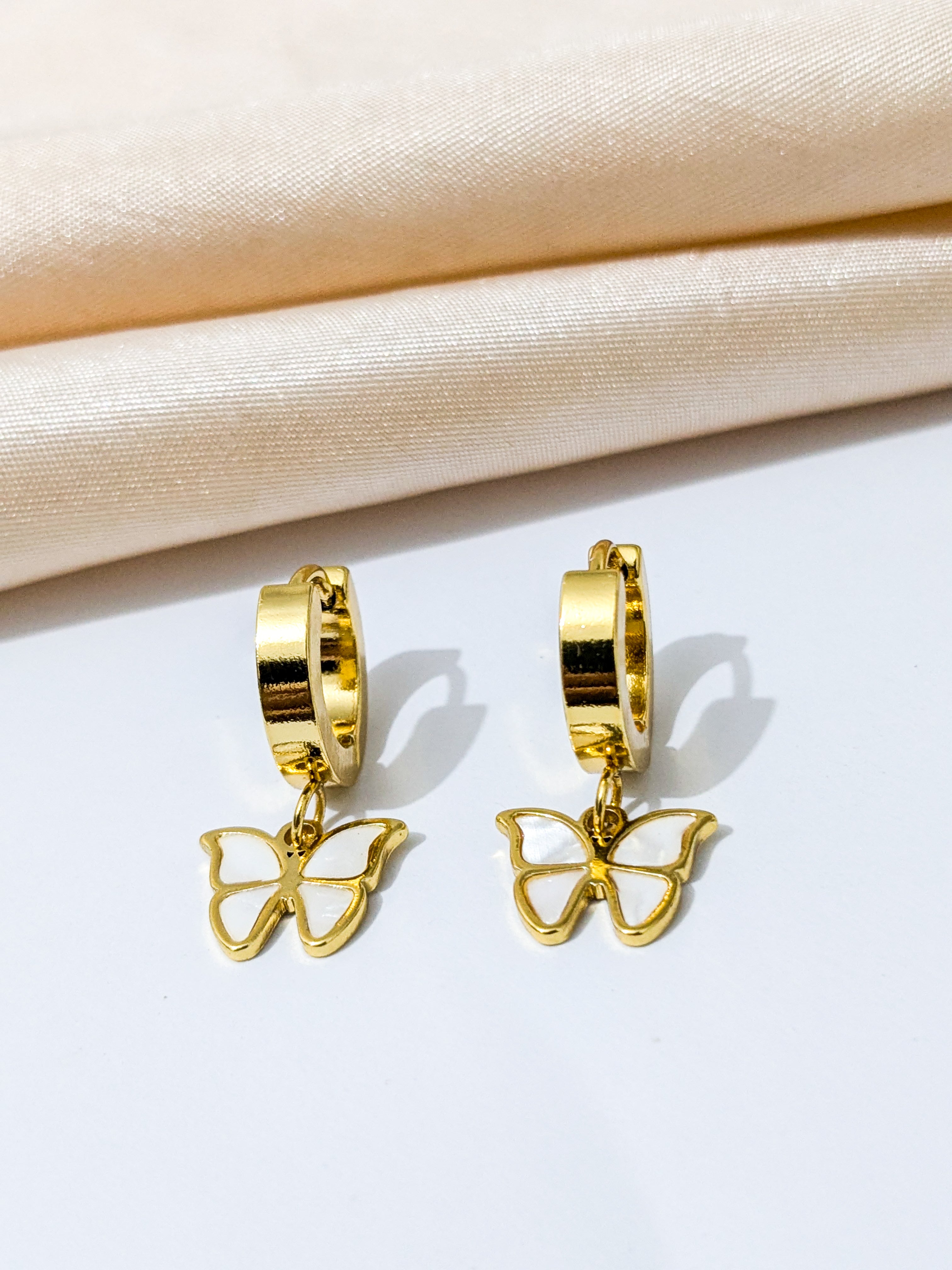 Gold hoop earrings with dangling butterfly charms