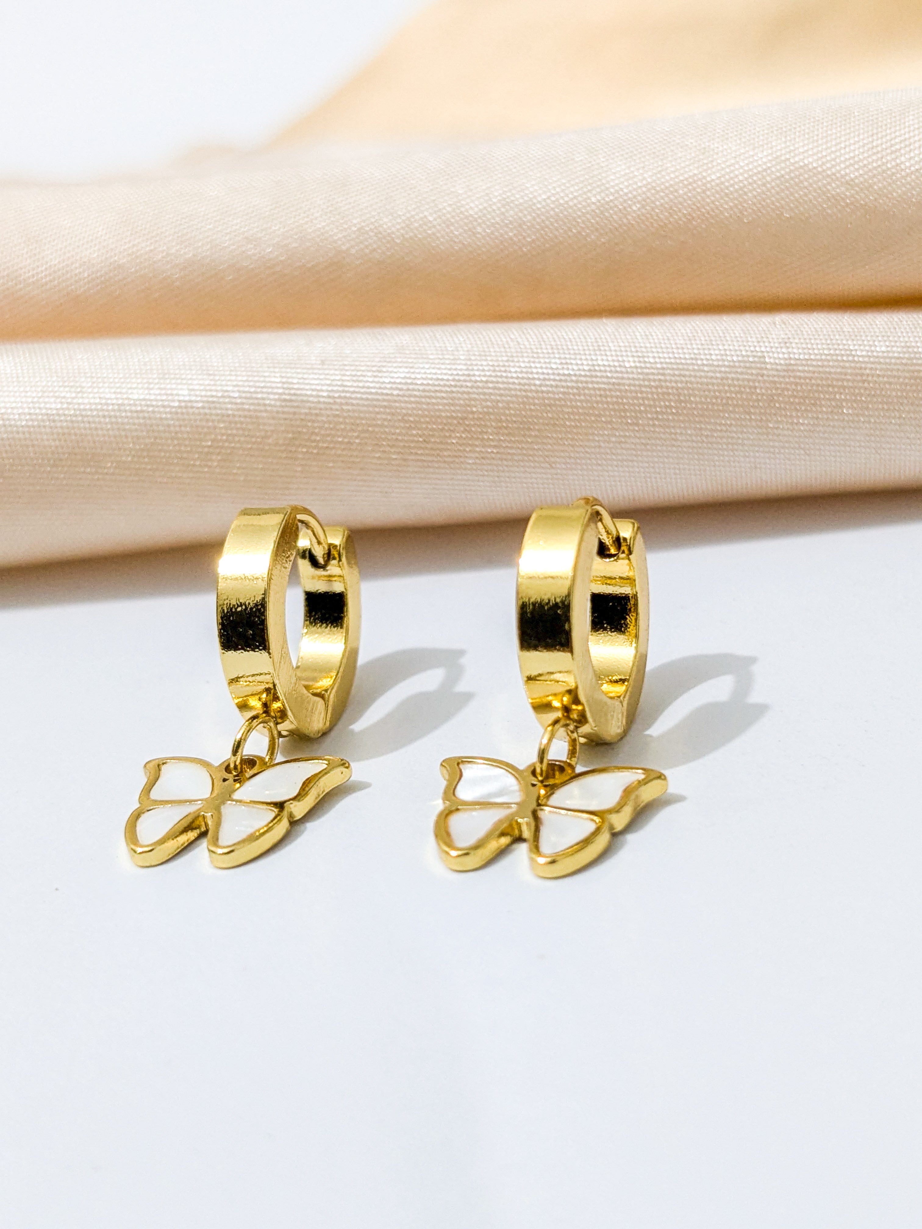 Gold hoop earrings with dangling butterfly charms