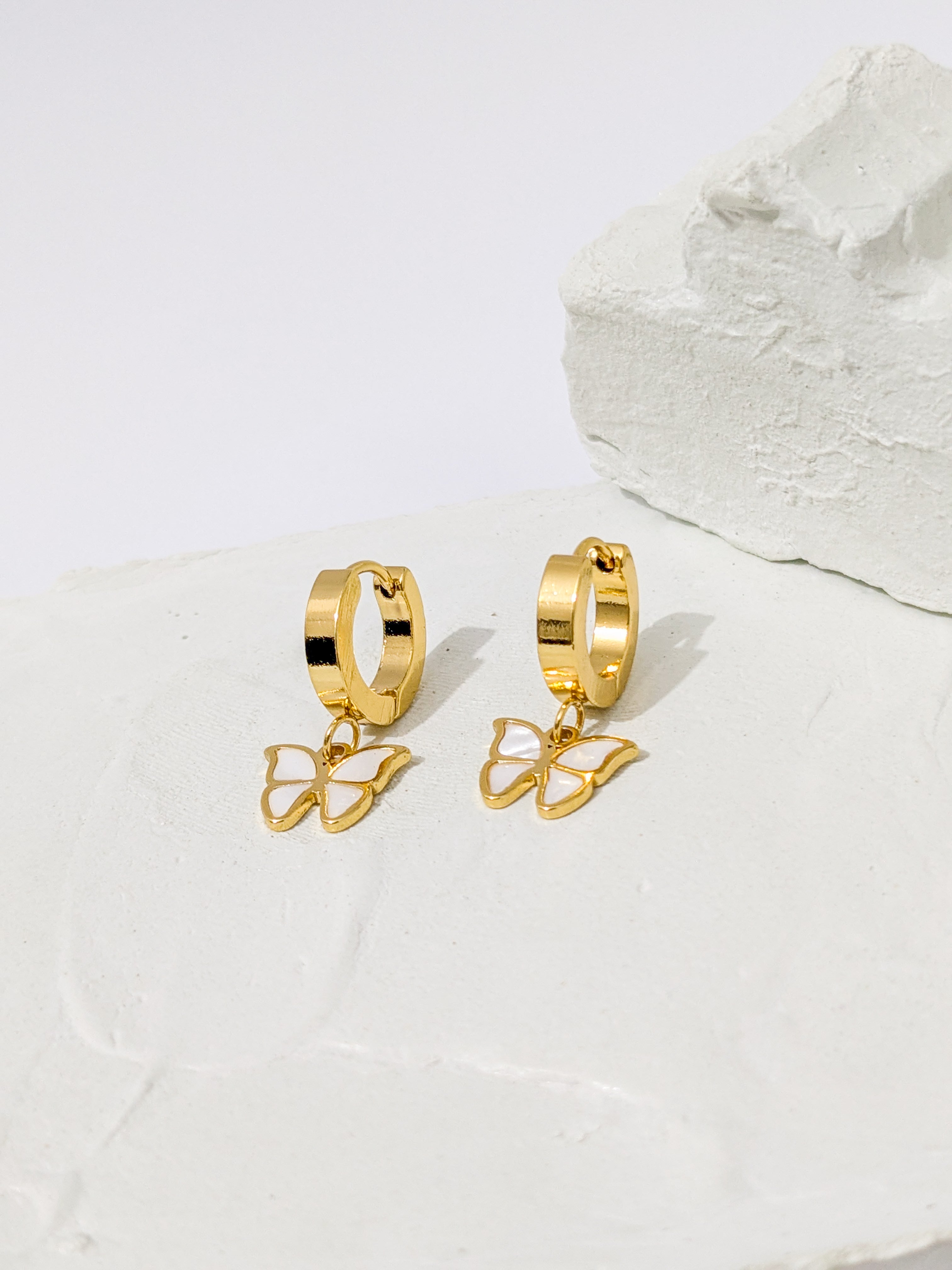 Gold hoop earrings with dangling butterfly charms